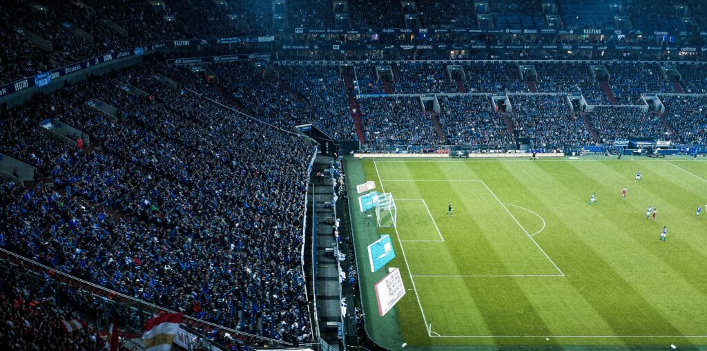 soccer players on green game field