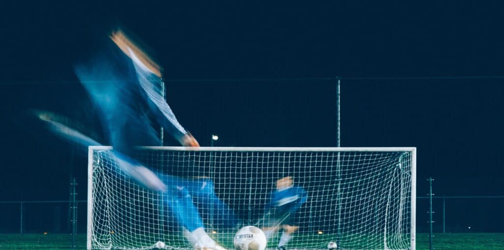 timelapse photo of soccer player kicking ball