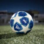 white and blue soccer ball on green grass field